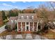 Brick colonial home with a large front porch and mature trees at 5401 Sunningdale Dr, Charlotte, NC 28277