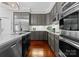Gray kitchen cabinets, stainless steel appliances, and hardwood floors at 5401 Sunningdale Dr, Charlotte, NC 28277