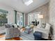 Sunroom features brick accent wall, comfortable seating, and access to deck at 5401 Sunningdale Dr, Charlotte, NC 28277