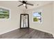 Bright bedroom with ceiling fan, full-length mirror, and hardwood floors at 5528 Queen Anne Rd, Charlotte, NC 28217