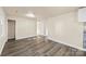 Bright dining room with grey vinyl flooring and access to kitchen at 5528 Queen Anne Rd, Charlotte, NC 28217