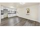 Modern kitchen with white cabinets, mosaic backsplash, and grey vinyl flooring at 5528 Queen Anne Rd, Charlotte, NC 28217