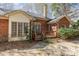 Brick house with a cozy wooden deck and a peaceful outdoor space with a combination of gravel and stepping stones at 5550 Monticello Nw Dr, Concord, NC 28027