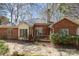 Brick house with a cozy wooden deck and a peaceful outdoor space with a combination of gravel and stepping stones at 5550 Monticello Nw Dr, Concord, NC 28027