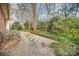 Landscaped backyard with a gravel pathway and lush greenery at 5550 Monticello Nw Dr, Concord, NC 28027