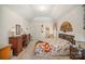 Main bedroom with floral bedding, wood furniture, and access to bathroom at 5550 Monticello Nw Dr, Concord, NC 28027