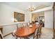 Formal dining room with wood table and chairs and view of living room at 5550 Monticello Nw Dr, Concord, NC 28027