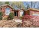 Attractive brick home showcasing a well-manicured lawn, mature trees, and charming architectural details at 5550 Monticello Nw Dr, Concord, NC 28027