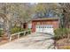 Brick home featuring an attached garage, a long driveway, and mature trees, providing ample parking and natural beauty at 5550 Monticello Nw Dr, Concord, NC 28027