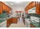 Kitchen with wood cabinets, green countertops and view into dining area at 5550 Monticello Nw Dr, Concord, NC 28027