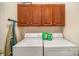 Laundry room with washer, dryer, and upper cabinets at 5550 Monticello Nw Dr, Concord, NC 28027