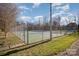 Community tennis courts with a chain-link fence at 5550 Monticello Nw Dr, Concord, NC 28027