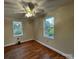 Well-lit bedroom with hardwood floors and ceiling fan at 6200 George Hildebran School Rd, Hickory, NC 28602