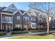 Well-maintained brick townhomes with beautiful landscaping and inviting entrances at 7542 Waverly Walk Ave # 7542, Charlotte, NC 28277