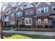 Attractive brick townhome featuring manicured landscaping and inviting curb appeal at 7542 Waverly Walk Ave # 7542, Charlotte, NC 28277
