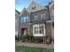 Charming brick townhome with a landscaped front yard and elegant architectural details at 7542 Waverly Walk Ave # 7542, Charlotte, NC 28277