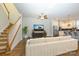 Inviting living room showcasing a staircase, media center, and an open view to the kitchen at 7542 Waverly Walk Ave # 7542, Charlotte, NC 28277