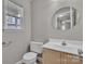 The bathroom features a vanity with a sink and a toilet at 8702 Wood Sorrel Ct, Matthews, NC 28105