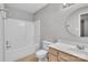 Bright bathroom features a shower-tub combo, neutral tile, and vanity with sink at 8702 Wood Sorrel Ct, Matthews, NC 28105