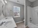The bathroom features a double sink vanity and a shower-tub combo, and natural light at 8702 Wood Sorrel Ct, Matthews, NC 28105