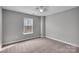 Bright and spacious bedroom includes a ceiling fan, window, and neutral paint at 8702 Wood Sorrel Ct, Matthews, NC 28105