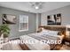 This staged bedroom features a large bed, modern decor and plenty of natural light at 8702 Wood Sorrel Ct, Matthews, NC 28105