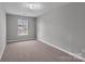 This bedroom has a large window, neutral carpet and paint, and is ready for your personal touch at 8702 Wood Sorrel Ct, Matthews, NC 28105