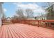 Expansive wooden deck, stained red, featuring a railing, perfect for relaxation and outdoor enjoyment at 8702 Wood Sorrel Ct, Matthews, NC 28105