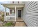 Charming front entrance with a black front door, white porch, and decorative landscaping at 8702 Wood Sorrel Ct, Matthews, NC 28105