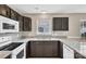 Features granite counters, stainless steel sink, white appliances, and dark wood cabinets at 8702 Wood Sorrel Ct, Matthews, NC 28105