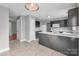 Open kitchen featuring tiled floor, white appliances, dark cabinets, and ample counter space at 8702 Wood Sorrel Ct, Matthews, NC 28105