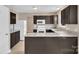 Features granite counters, stainless steel sink, white appliances, and dark wood cabinets at 8702 Wood Sorrel Ct, Matthews, NC 28105