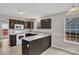 Modern kitchen featuring granite counters, white appliances, dark cabinets, and tiled flooring at 8702 Wood Sorrel Ct, Matthews, NC 28105