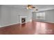 This spacious living room features a cozy fireplace and hardwood floors at 8702 Wood Sorrel Ct, Matthews, NC 28105