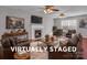 The virtually staged living room features a cozy fireplace and comfortable seating at 8702 Wood Sorrel Ct, Matthews, NC 28105