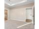 Bright bedroom featuring neutral walls and carpet, and an ensuite bathroom at 9181 Cherokee Dr, Hickory, NC 28601