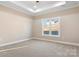 Well-lit bedroom with neutral walls and carpeting, offering a peaceful atmosphere at 9181 Cherokee Dr, Hickory, NC 28601