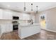 Modern kitchen with white cabinets, stainless steel appliances and an island at 9181 Cherokee Dr, Hickory, NC 28601