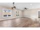 Living room with hardwood floors, ceiling fan, and large windows at 9181 Cherokee Dr, Hickory, NC 28601