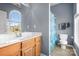 Clean bathroom with shower, toilet and wood vanity at 9729 Capella Nw Ave, Concord, NC 28027