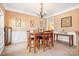 Bright dining room with a charming chandelier and hardwood floors at 9729 Capella Nw Ave, Concord, NC 28027