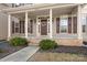 Brick porch with columns, a decorative wreath, and landscaping at 9729 Capella Nw Ave, Concord, NC 28027