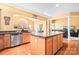 Kitchen with island, granite countertops, and stainless steel appliances at 9729 Capella Nw Ave, Concord, NC 28027