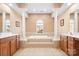 Elegant main bathroom with double vanities and a soaking tub at 9729 Capella Nw Ave, Concord, NC 28027