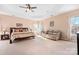 Relaxing main bedroom with ceiling fan and sitting area at 9729 Capella Nw Ave, Concord, NC 28027