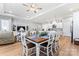 Bright dining area with white table and chairs, hardwood floors, and open concept to kitchen at 1025 Lake Como Dr, Monroe, NC 28110