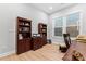 Bright home office with built-in bookcases and hardwood floors at 1025 Lake Como Dr, Monroe, NC 28110