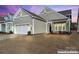 Two-car garage and front yard of charming house at 1025 Lake Como Dr, Monroe, NC 28110