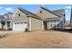 Two-car garage and front yard of charming house at 1025 Lake Como Dr, Monroe, NC 28110