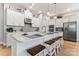 Modern kitchen with white cabinets, large island, and stainless steel appliances at 1025 Lake Como Dr, Monroe, NC 28110